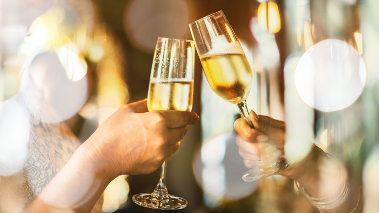two glasses of champagne clinking