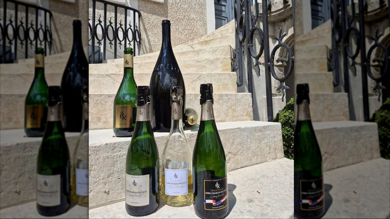 several champagne bottles on house steps