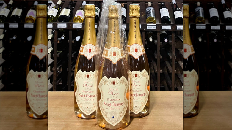three bottles of rose champagne in wine shop