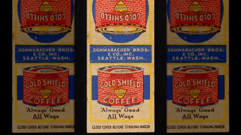 Mirrored image of an old matchbook, printed with red Gold Shield coffee can and writing