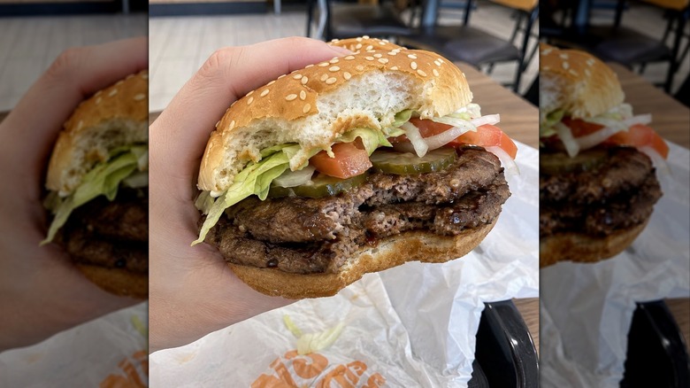 Hand holding Burger King Whopper