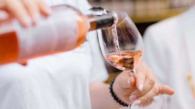 Person pouring rosé wine from Aix-en-Provence