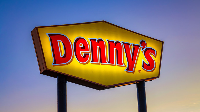 Denny's sign against colorful sky
