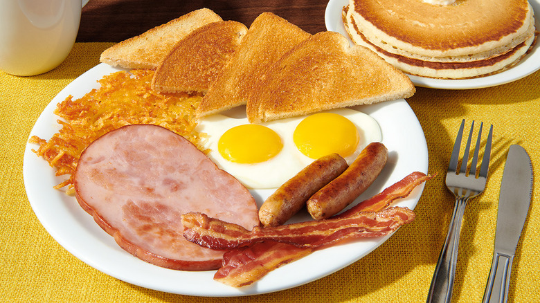 Denny's Lumberjack Slam on white plate and yellow placemat