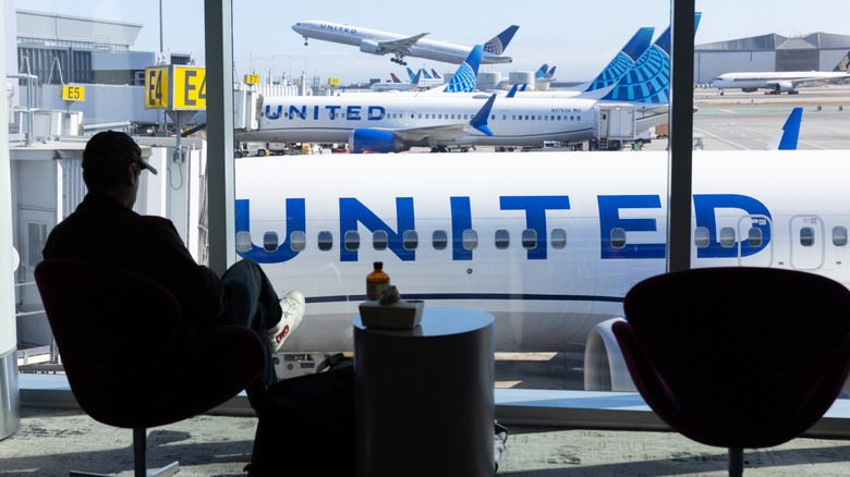 Silhouette of someone inside of an airport terminal