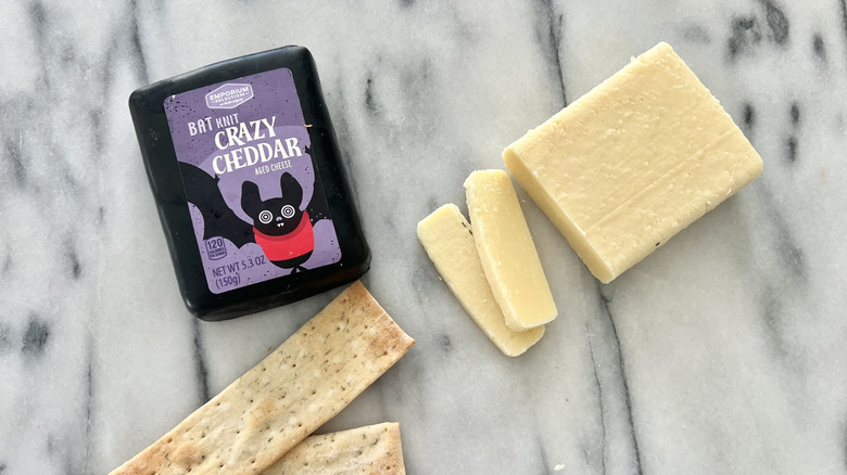 Aldi Bat Knit Crazy Cheddar cheese cut on cheese board.
