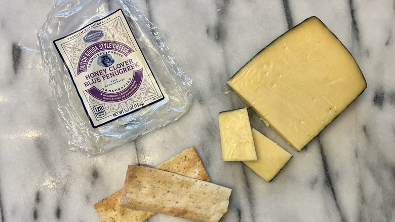 Aldi Honey Clover Blue Fenugreek Dutch Gouda Style Cheese cut on cheese board.