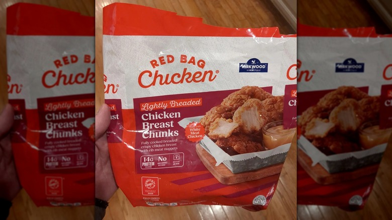Person holding a bag of Kirkwood chicken breast chunks