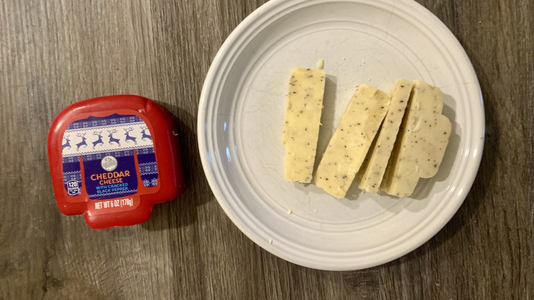Aldi cheddar cheese in sweater truckle on table