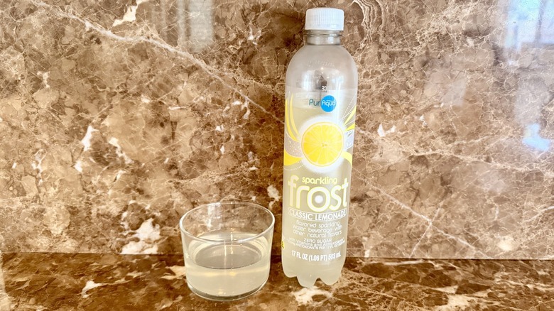 Classic Lemonade Frost Water bottle next to a little poured in a glass