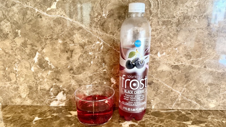Black Cherry Frost Water bottle next to a little poured in a glass