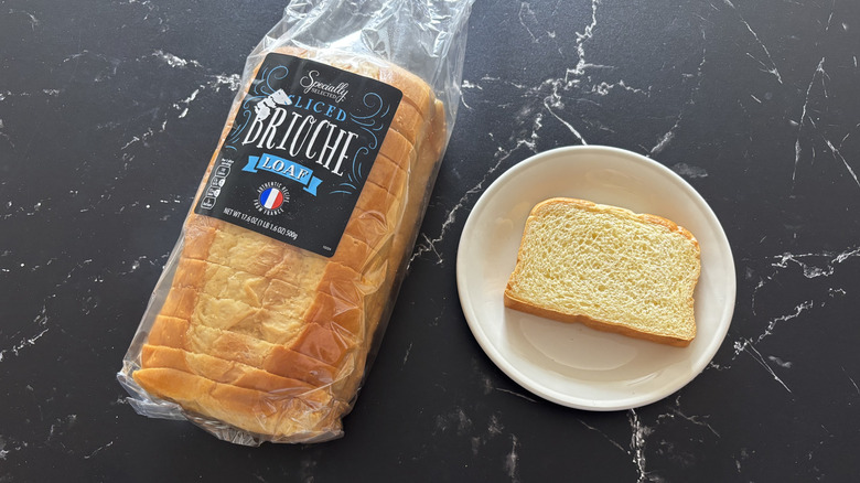 Aldi Specially Selected brioche loaf in a bag next to slice on plate