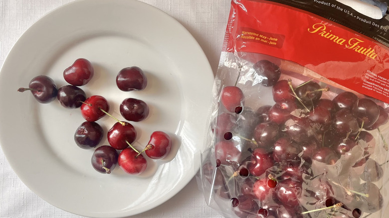 Bag of cherries and fruit on a plate