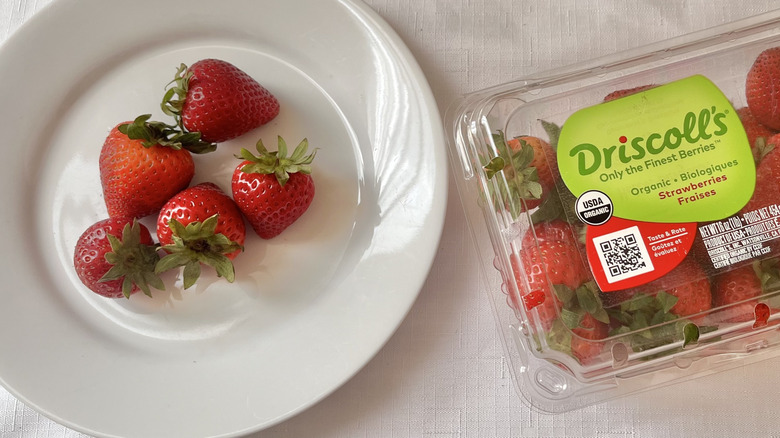 Box of strawberries and fruit on a plate