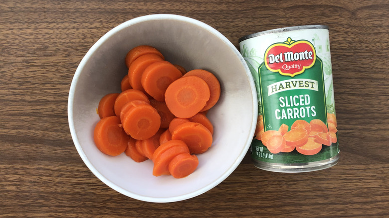 Del Monte canned harvest sliced carrots in a bowl.