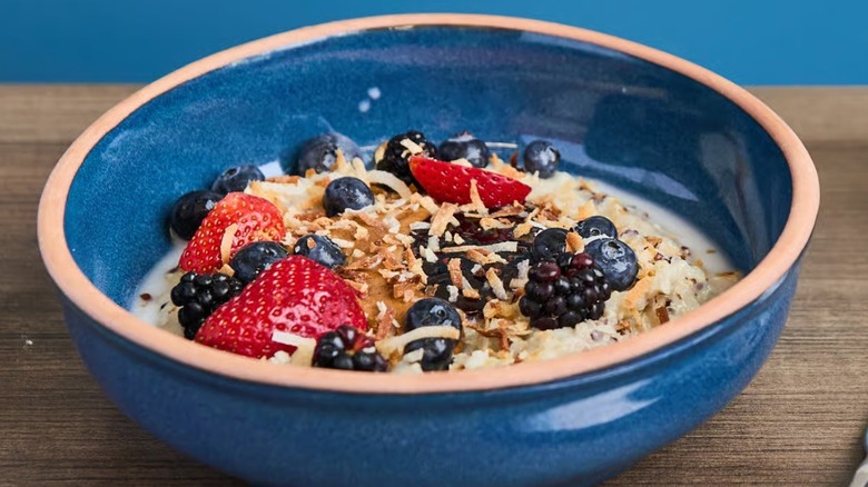 Almond butter coconut porridge topped with fresh berries served at Snooze