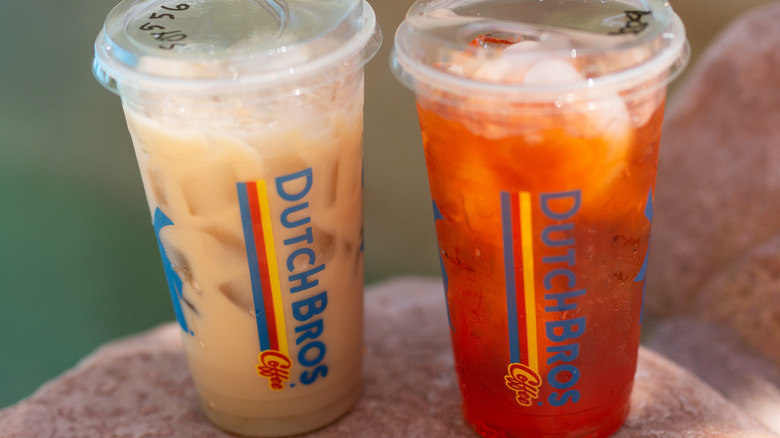 Iced coffee and iced rebel side by side on rock