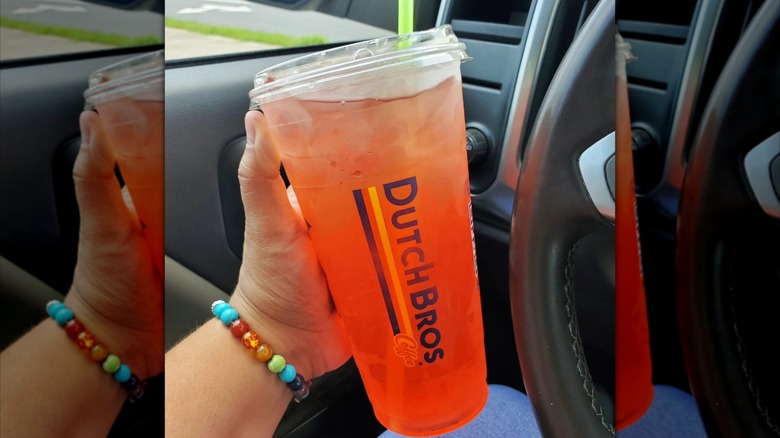 Person holding Palm Beach tea in a car