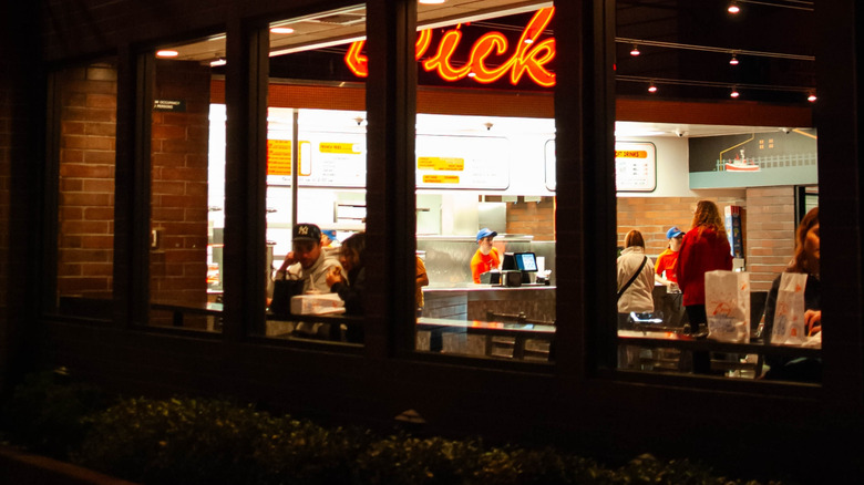 Exterior shot of a West Coast fast food chain with diners inside