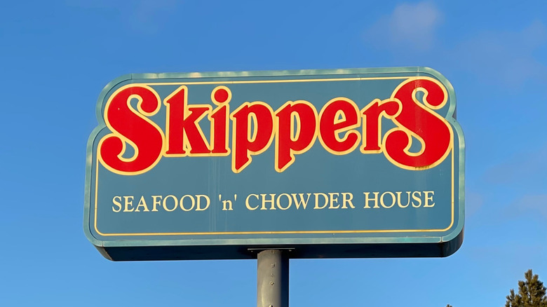 Skippers West Coast fast food chain sign against a blue sky