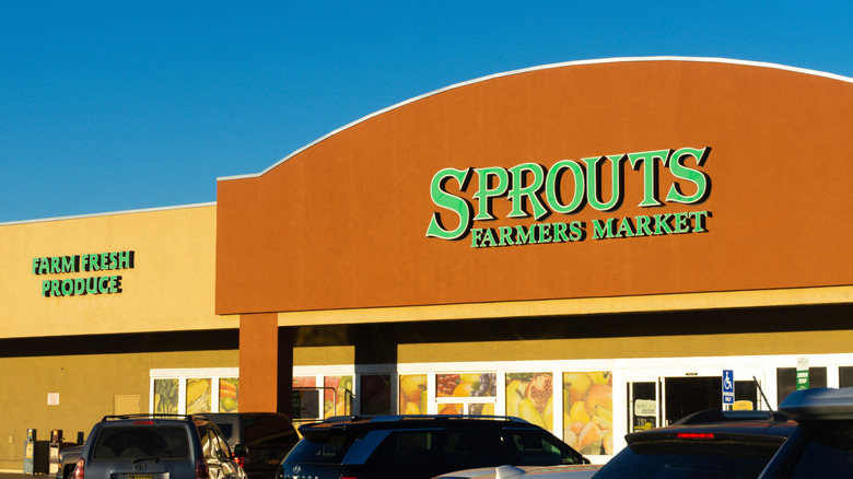Sprouts grocery store building outside against blue sky