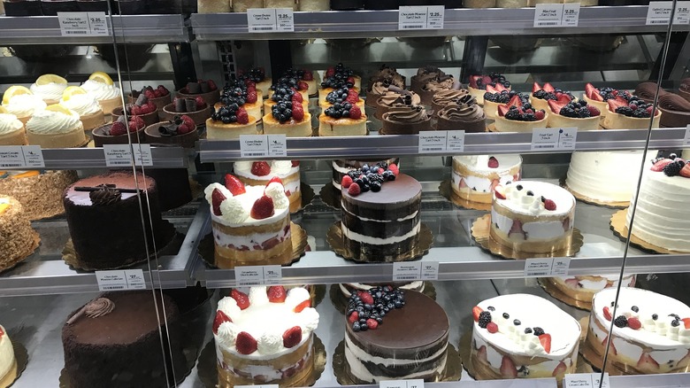 Cakes and desserts at the bakery section of Whole Foods in glass case