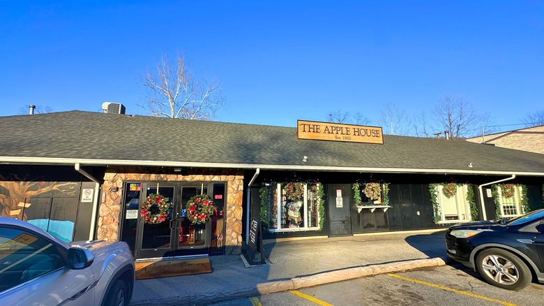 A grey-roofed building with a sign that says The Apple House