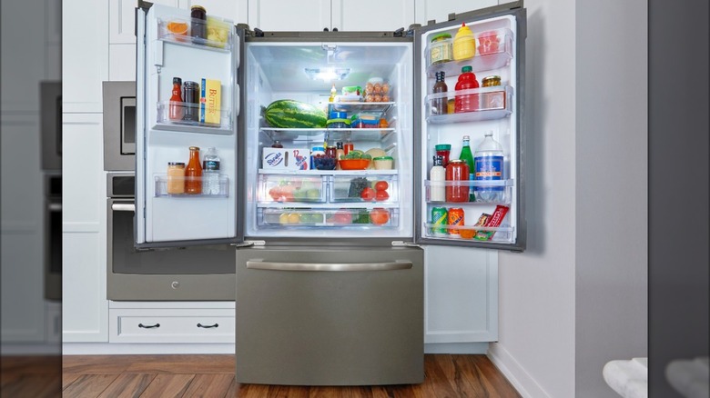 GE fridge with open doors and full of groceries