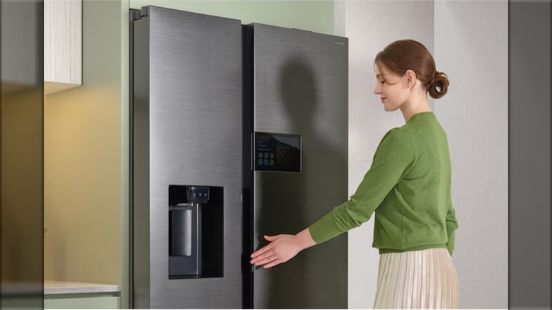 Woman in front of a stainless steel Samsung fridge