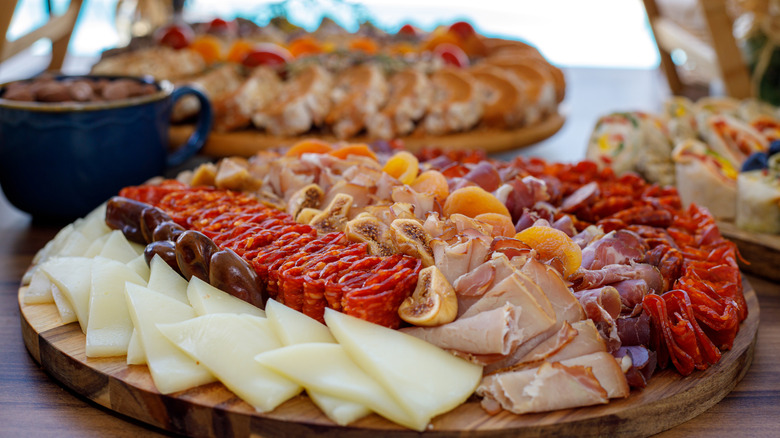 Charcuterie board with meats, fruits, and cheeses