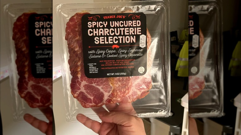 Person holding a package of Spicy Uncured Charcuterie Collection