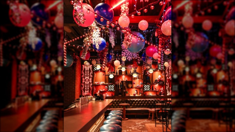 Interior of Here Kitty Kitty Vice Den with decorations and leather stools at the bar