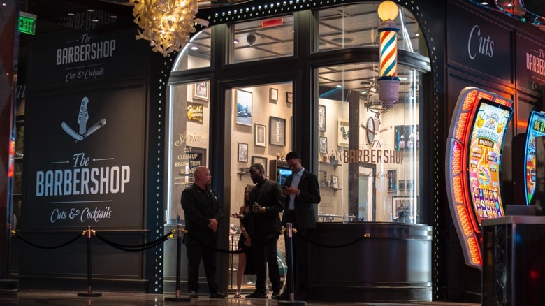 People standing in the doorway of The Barbershop Cuts & Cocktails