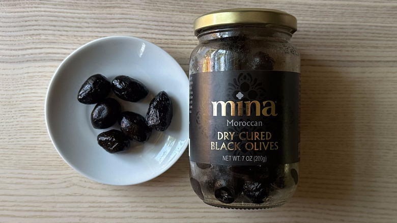 Mina black olives on small white plate