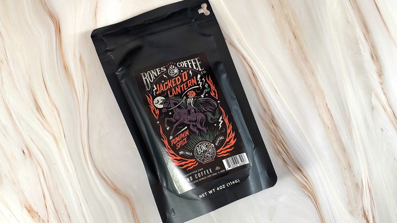 Bag of Jacked 'O' Lantern Bones Coffee on marble surface