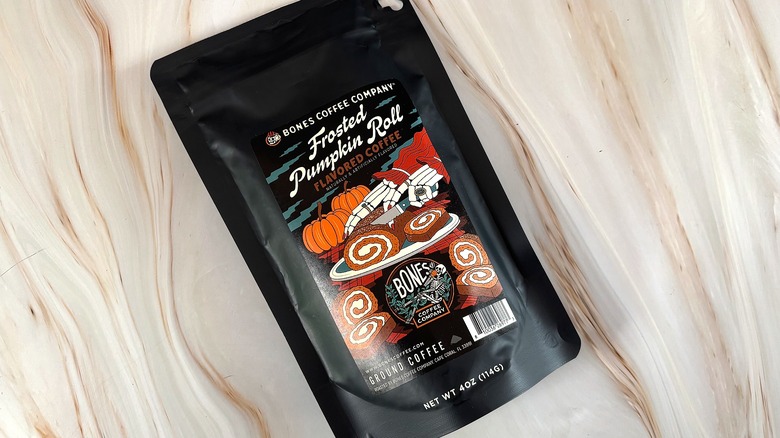 Bag of Frosted Pumpkin Roll Bones Coffee on marble surface