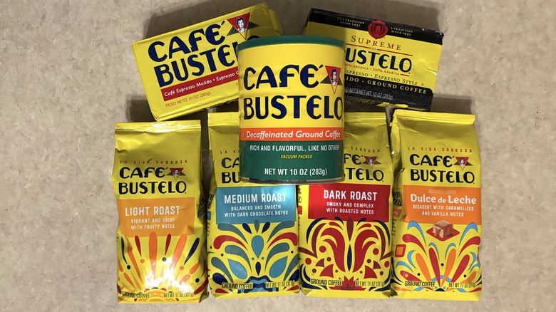A variety of Cafe Bustelo ground coffees in packaging on neutral background.