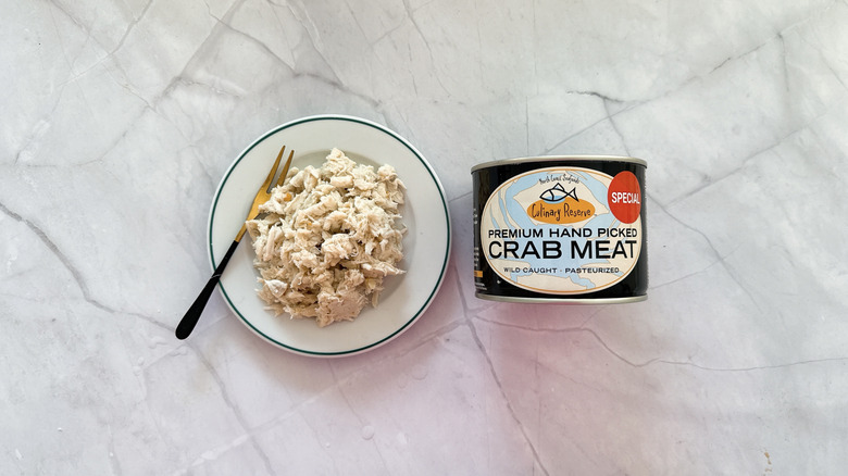 Crabmeat on a plate next to a can of Culinary Reserve crab meat.
