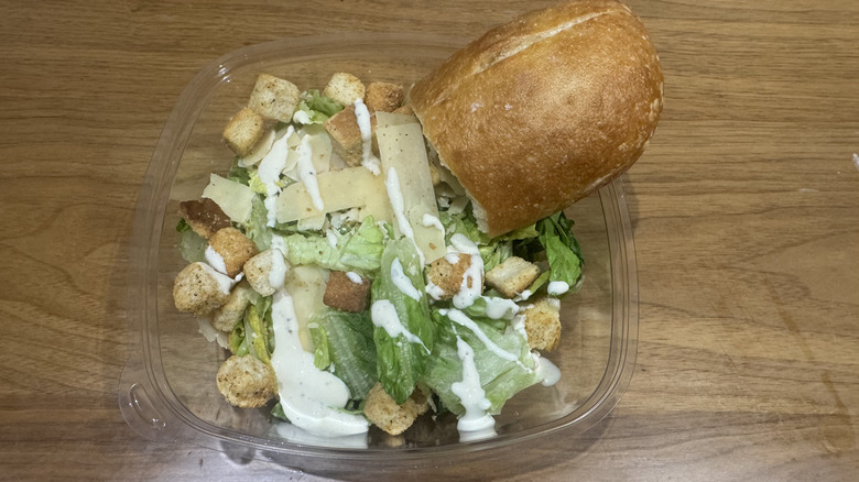 Panera Bread's Caesar salad on a wooden surface.