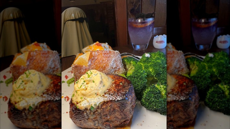 Thick piece of steak, broccoli, and baked potato at Outback