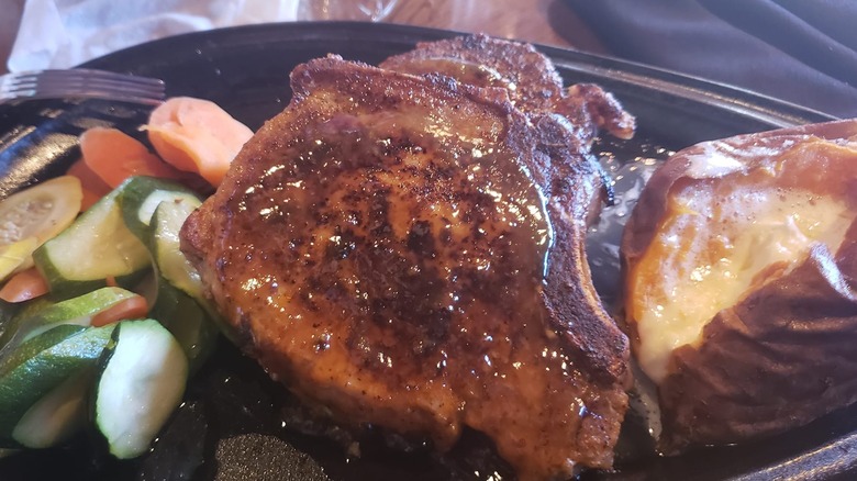 Caramel Mustard Glazed Pork Chops at Outback Steakhouse alongside potato and vegetables