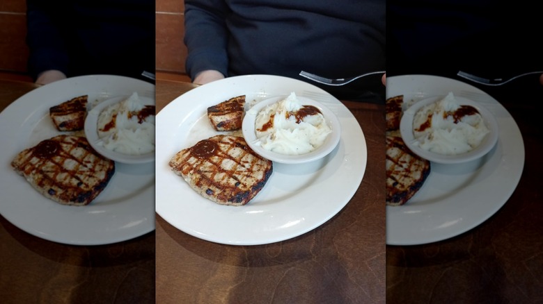 Mesquite Grilled Pork Chops at Logan's Roadhouse on white plate with side of mashed potatoes