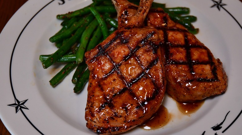 Prime Pork Chops at Saltgrass Steakhouse on white plate with side of green beans