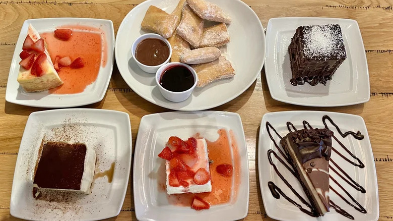 Various Olive Garden desserts and cakes on a table