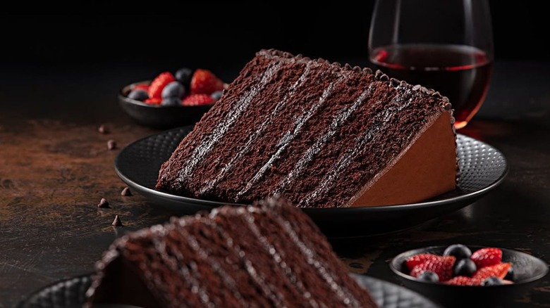 A piece of P.F. Chang's The Great Wall of Chocolate sits on its side on a black plate