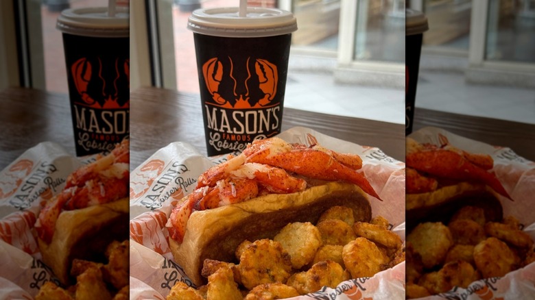 Mason's Famous Lobster Rolls lobster roll sitting in a basket with potato wedges next to a fountain drink.