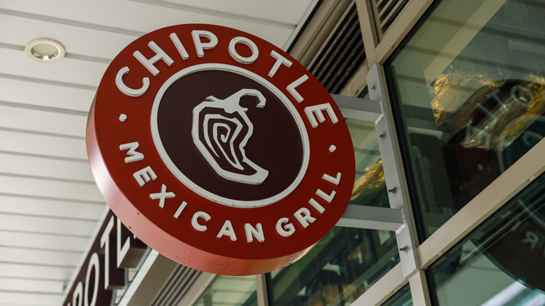 A red, brown, and white Chipotle restaurant logo