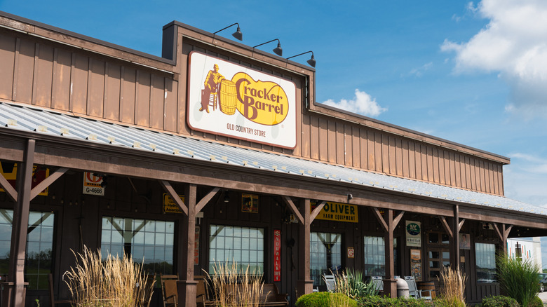 Front of a Cracker Barrel restaurant with a logo and porch