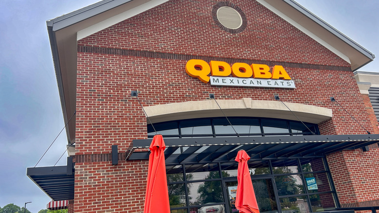 A face-brick building with a Qdoba logo on the front
