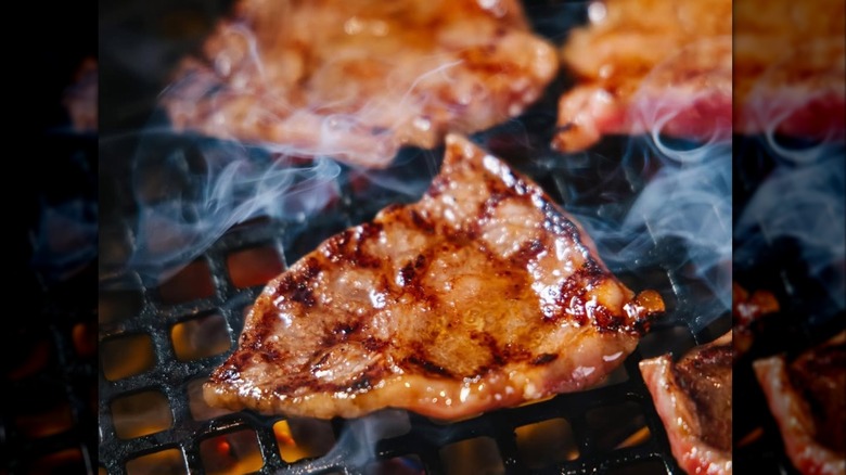Thin slices of steak on a grill